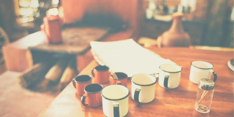 coffee cups on a table with work papers