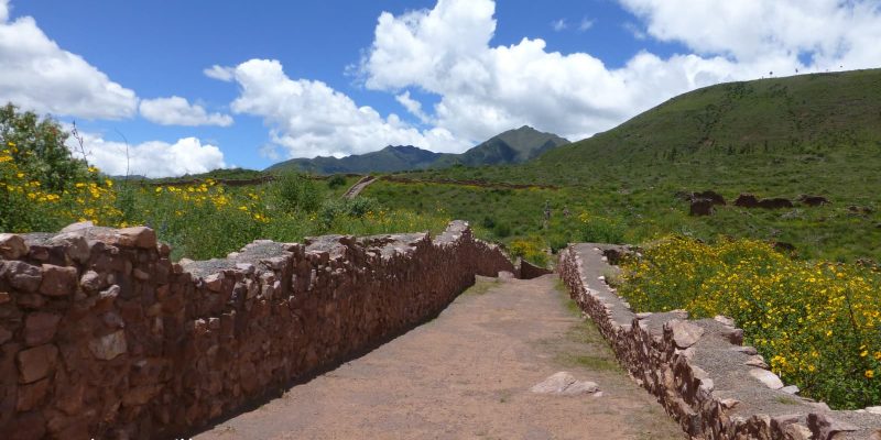 Path with green hills and blue sky in Peru