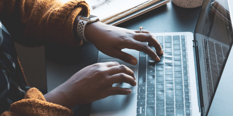 writing blog post woman hands typing on laptop
