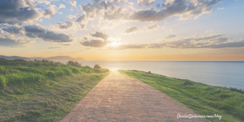 stone path leading to horizon with clouds and sunset