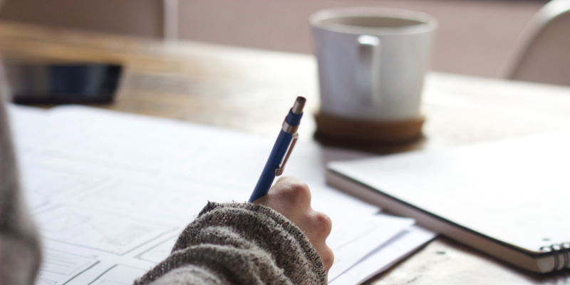 woman hand writing at desk